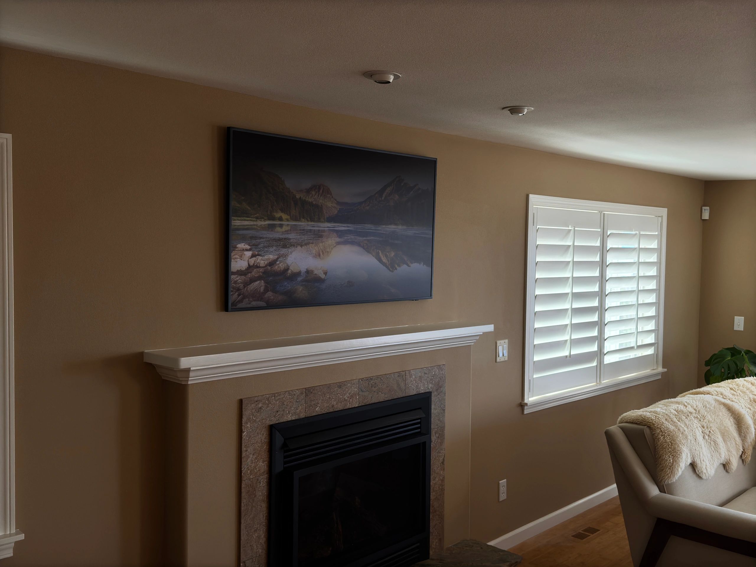 Wall-mounted OLED TV in modern room